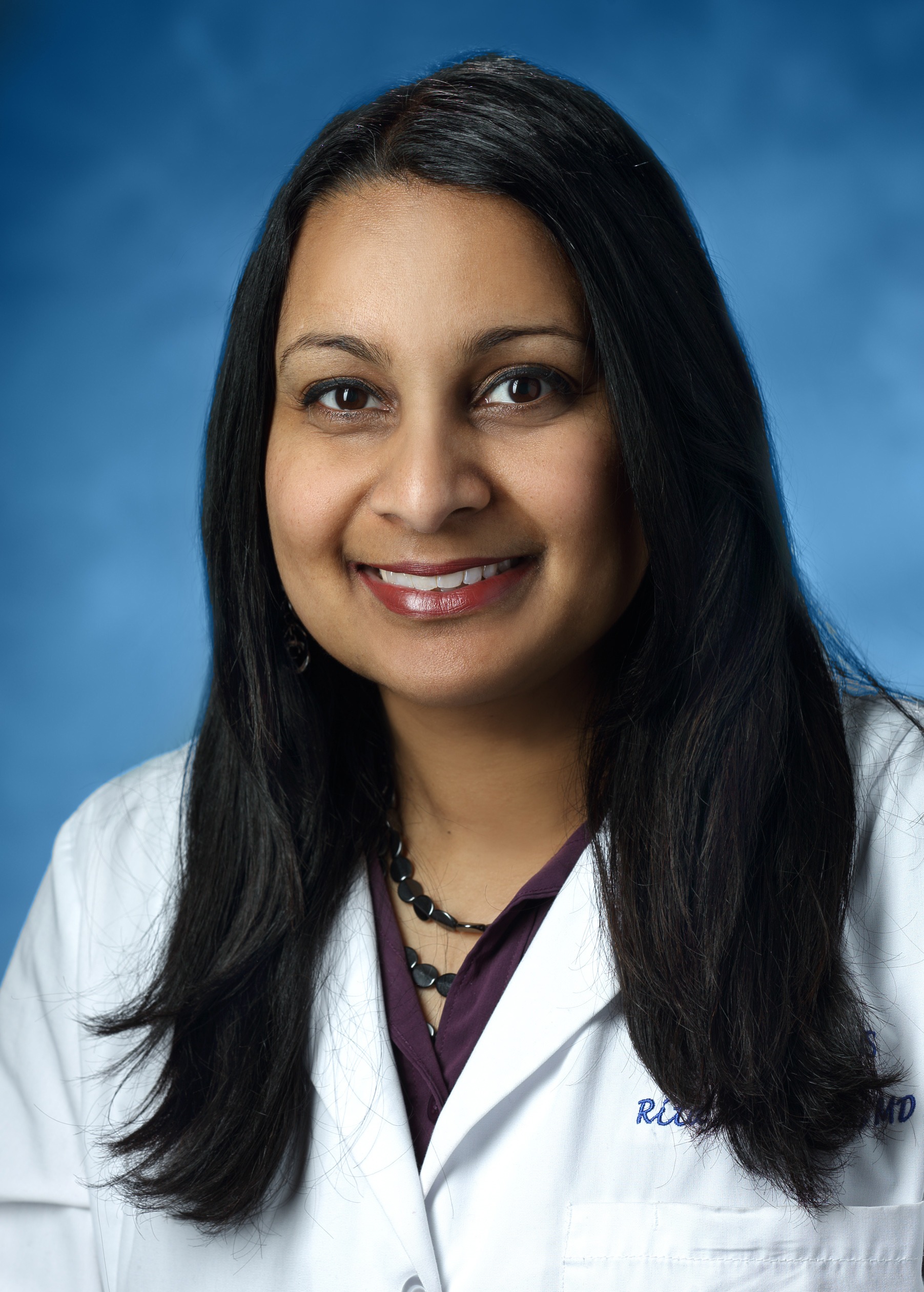 Dr. Rita Kalyani headshot on blue background